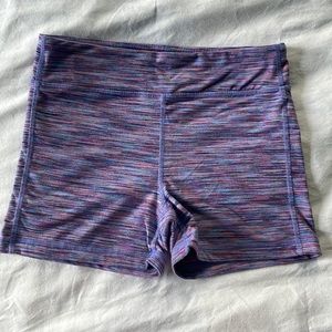 Athleta girl fitted stretchy shorts. Size L/12. 4” inseam. Cute purple pattern!